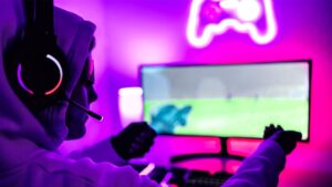 How Neon Signs Became a Smart Upgrade for Modern Gaming Rooms Gamer focus playing with neon lighting in background