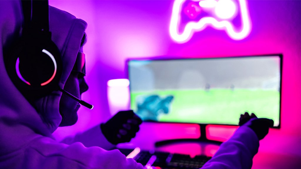 Gamer focus playing with neon lighting in background