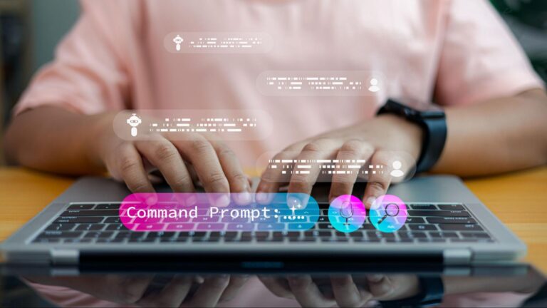 A person typing prompt on a laptop