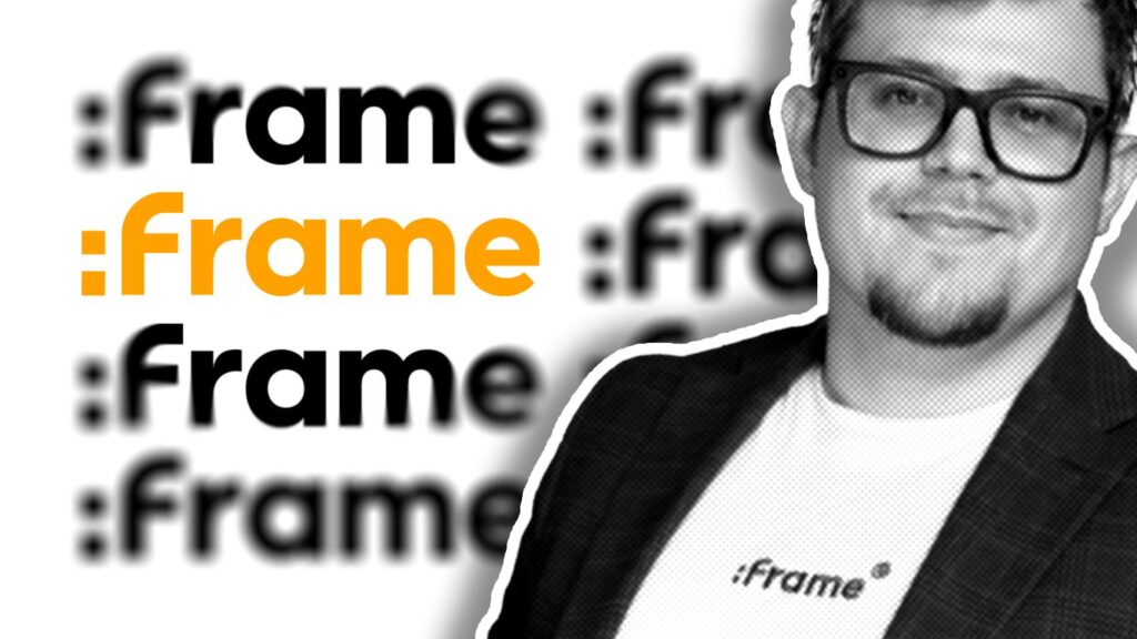 Man wearing glasses and dark blazer stands before repeated :Frame branding logos in black and orange