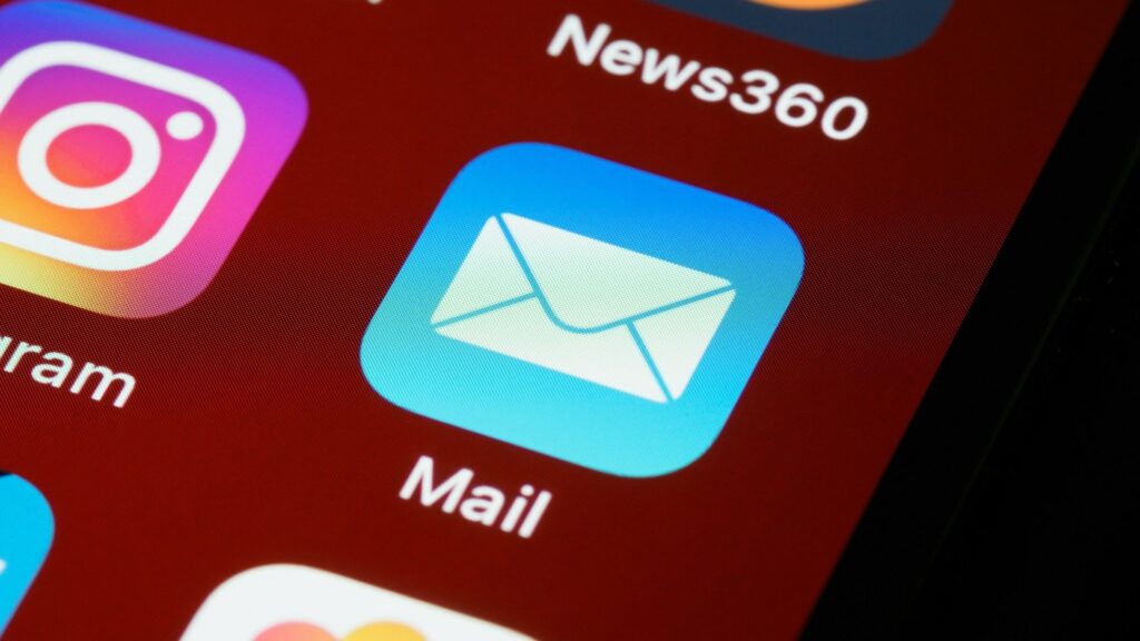 Mail app icon with envelope symbol on smartphone home screen alongside Instagram and News360 apps.